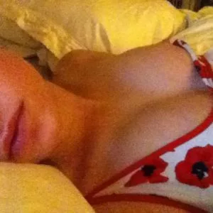 Brie Larson laying in bed with tits popping out of her shirt