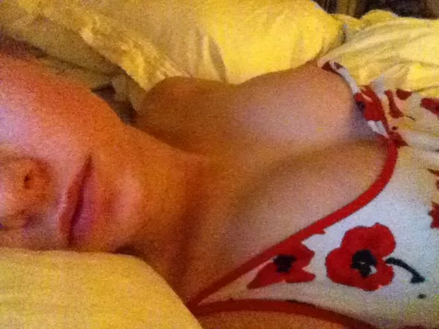 Brie Larson laying in bed with tits popping out of her shirt