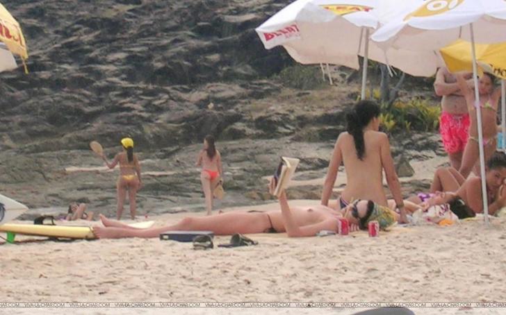 Charlize Theron topless sun tanning