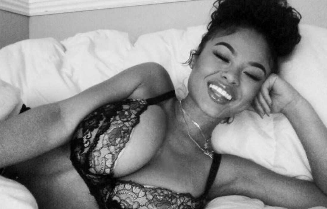 India Love in black bra smiling