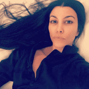 sexy pic of Kourtney Kardashian in her bed with pouty lips