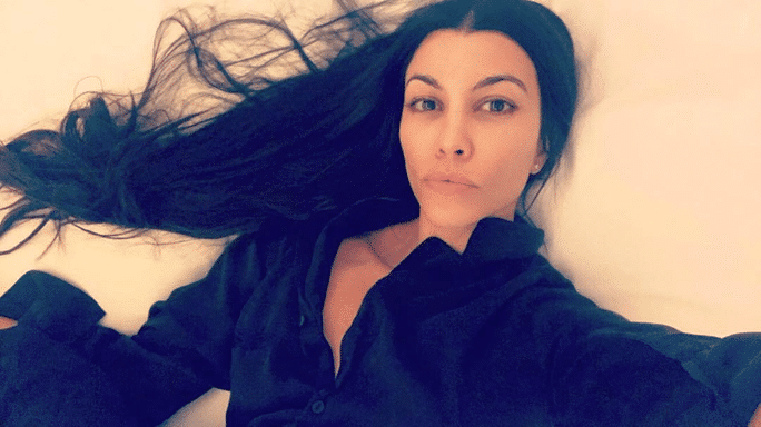 sexy pic of Kourtney Kardashian in her bed with pouty lips