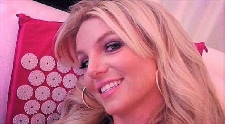 Britney Spears sexy selfie in her bed looking into the camera and smiling