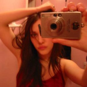 celebrity kat dennings taking a photo of herself with a normal camera