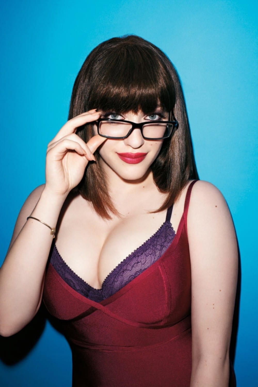 Kat Dennings looking sexy with thick rimmed back eyeglasses and showing off her cleavage