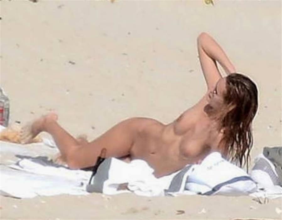 Model Edita Vilkeviciute lounging in the nude at the beach