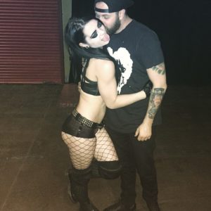 pic of WWE Paige in black lingerie and fish tights hugging a dude