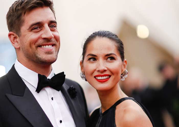 the beautiful olivia munn and aaron rodgers in suit and tie