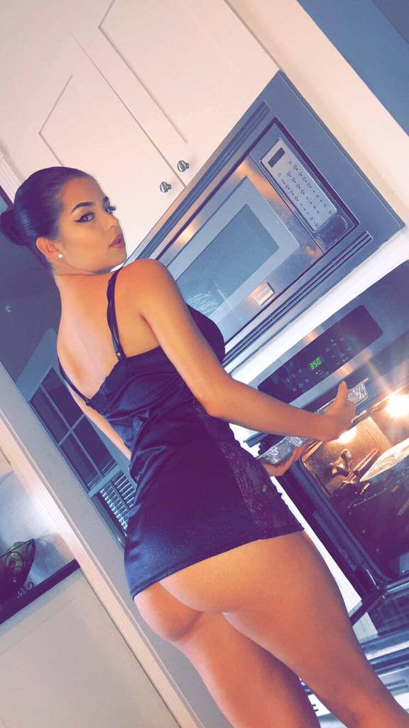 Demi Rose Mawby cheeks hanging out of her ass while putting food in the oven