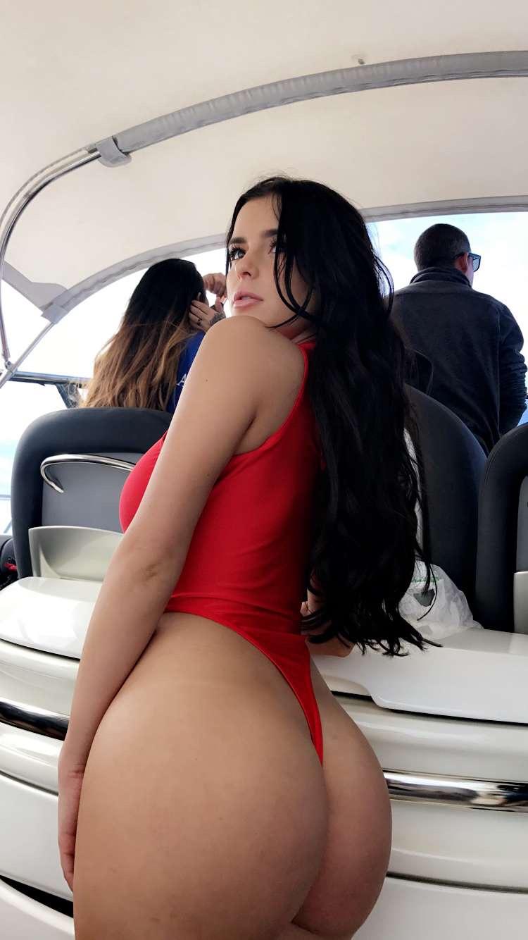 Demi Rose's ass in a red one piece suit