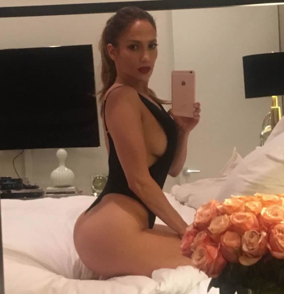 Jennifer Lopez on her knees wearing a one piece Instagram photo