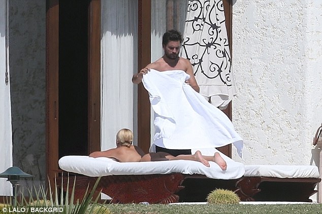 Scott Disick covering up Sofia Richie with a towel